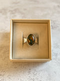 Handmade sterling silver ring with oval moss agate and carnelian gemstone in a bezel setting, artisan silver jewellery displayed in a neutral jewellery box, ready to ship.